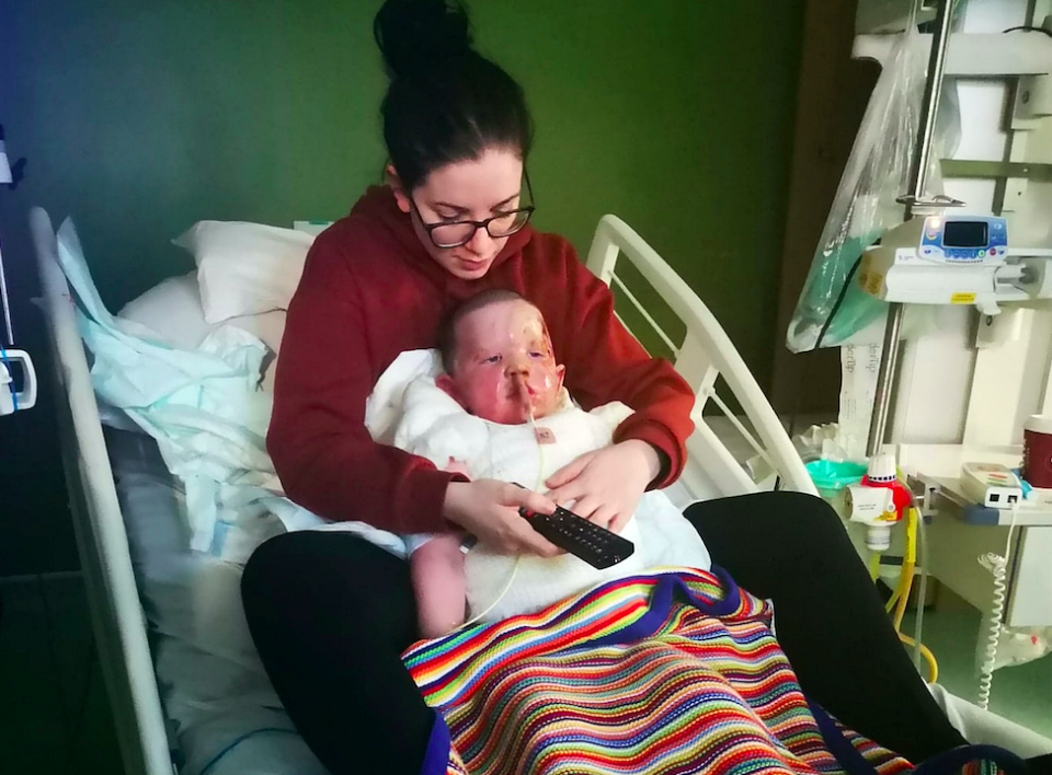 Harley's mum Erin sits with him in hospital as he recovered from his injuries. (SWNS)