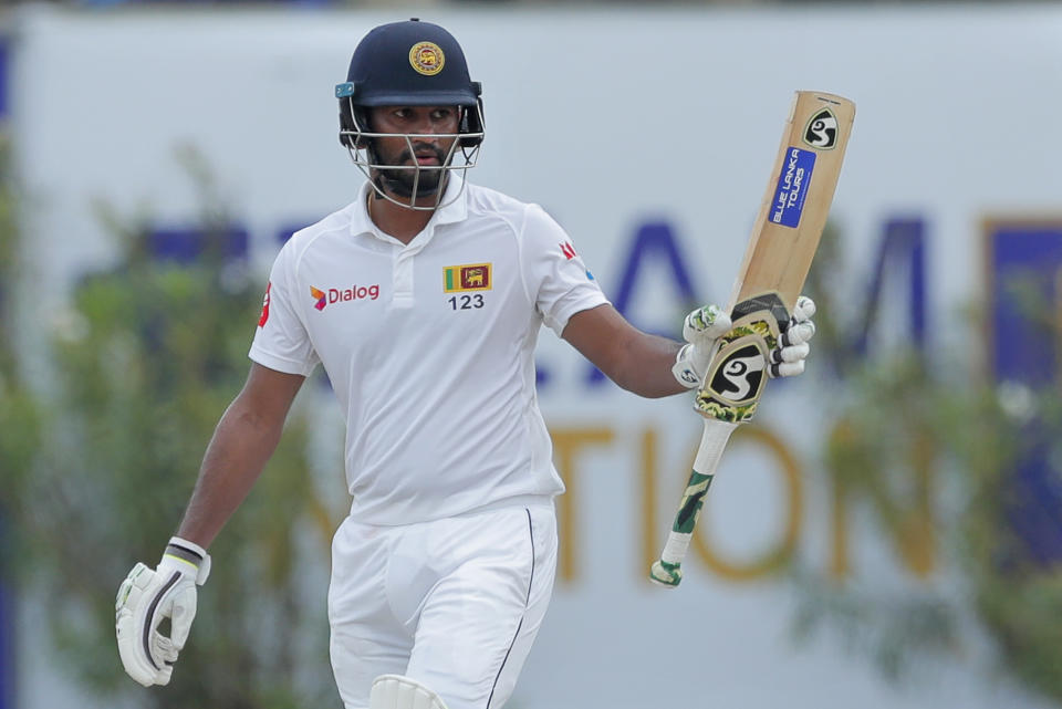 Sri Lanka's Dimuth Karunaratne celebrates scoring a half century during the fourth day of the first test cricket match between Sri Lanka and New Zealand in Galle, Sri Lanka, Saturday, Aug. 17, 2019. (AP Photo/Eranga Jayawardena)