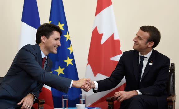 Canadian Prime Minister Justin Trudeau (L) and French President Emmanuel Macron shake hands during a bilateral meeting as they attend the Summit of the Heads of State and of Government of the G7, the group of most industrialized economies, plus the European Union, on May 26, 2017 in Taormina, Sicily. The leaders of Britain, Canada, France, Germany, Japan, the US and Italy will be joined by representatives of the European Union and the International Monetary Fund (IMF) as well as teams from Ethiopia, Kenya, Niger, Nigeria and Tunisia during the summit from May 26 to 27, 2017. / AFP PHOTO / POOL / STEPHANE DE SAKUTIN (Photo credit should read STEPHANE DE SAKUTIN/AFP/Getty Images)