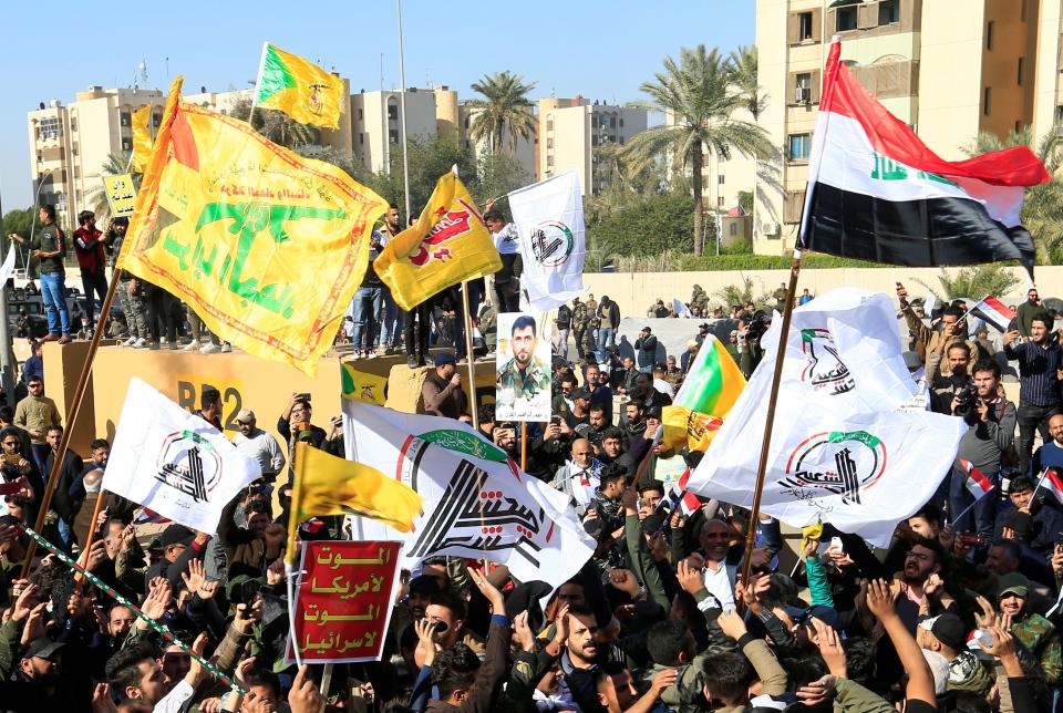 Protesters and militia fighters gather to condemn air strikes on bases belonging to Hashd al-Shaabi (paramilitary forces), outside the main gate of the U.S. Embassy in Baghdad, Iraq December 31, 2019. (Photo: Thaier al-Sudani/Reuters)