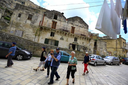 Tourists walk on a street in Matera's Sassi, southern Italy April 30, 2015. REUTERS/Tony Gentile