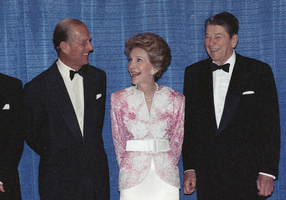 FILE - In this Wednesday, May 17, 1989 file photo, Britain's Prince Philip talks with former US President Ronald Reagan, right, and his wife Nancy Reagan prior to a dinner in Beverly Hills, Calif. The Prince presented the Winston Churchill Award to the former president. Buckingham Palace says Prince Philip, husband of Queen Elizabeth II, has died aged 99. (AP Photo/Doug Pizac, File)