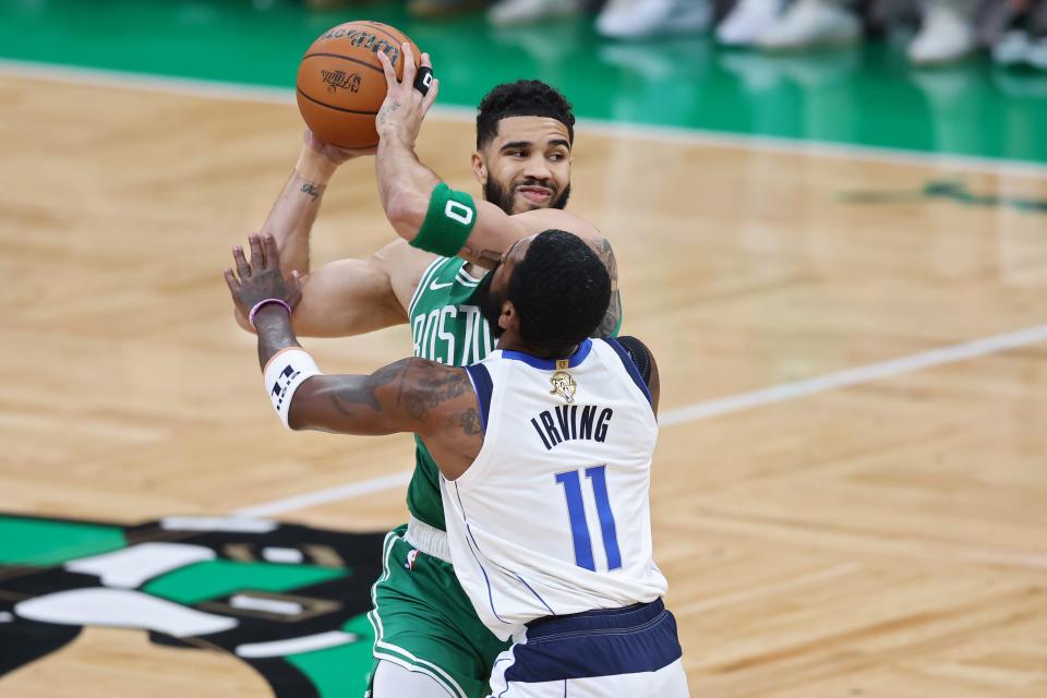 Jayson Tatum under pressure from Kyrie Irving.