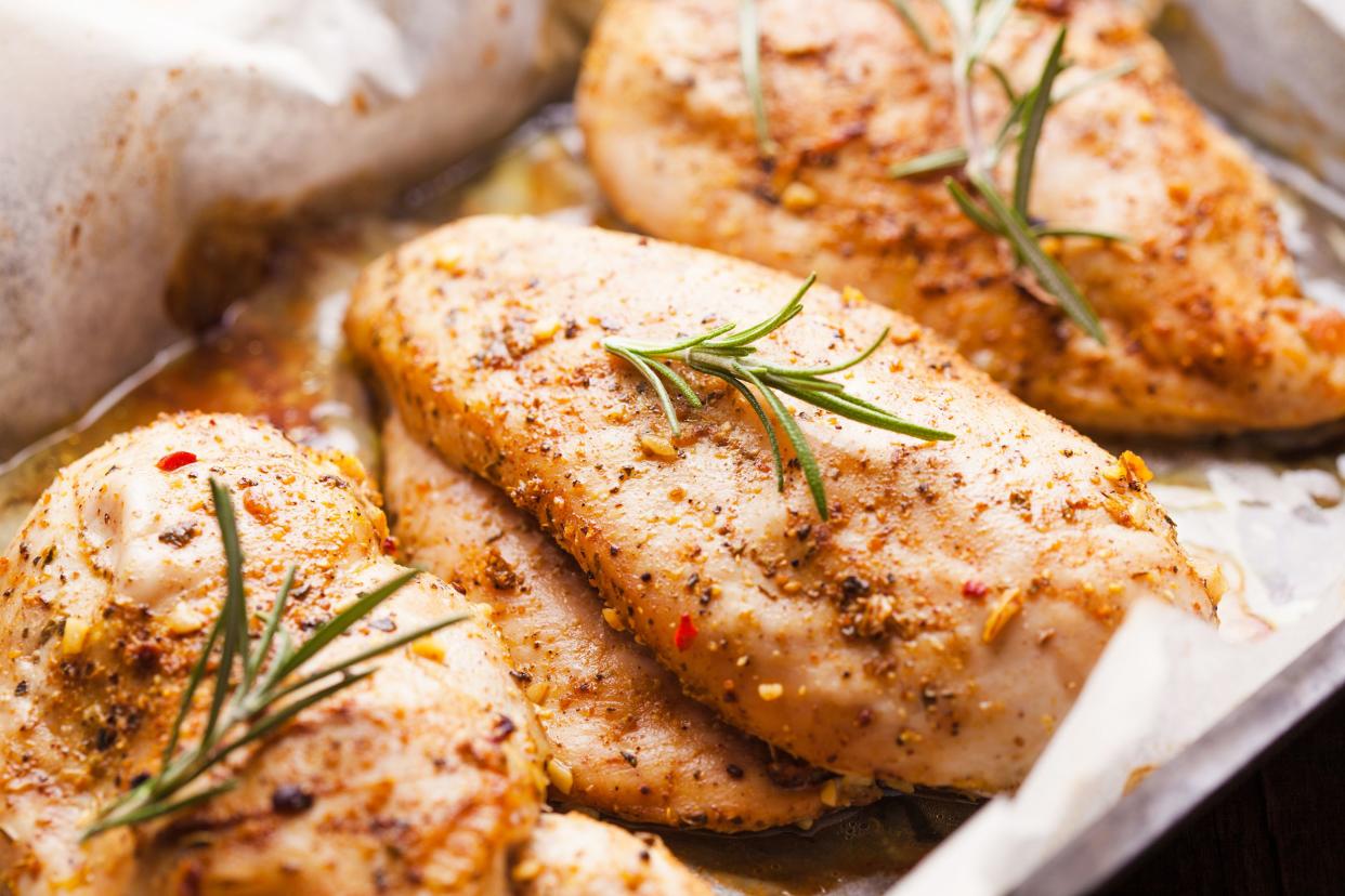 Closeup of baked chicken breasts on parched paper