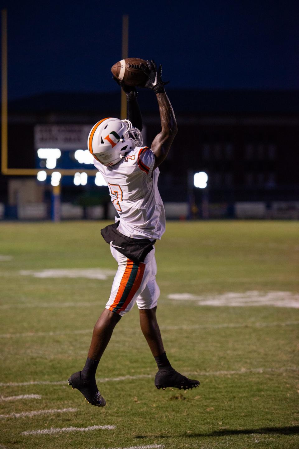 Dunbar's Anthony Benjamin reaches for the reception during Friday's game at Charlotte High