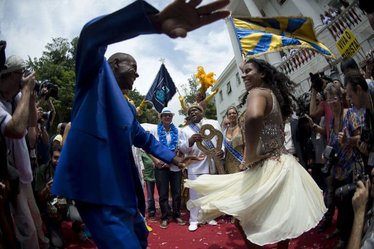 King Momo (C, backgroud) holds the key of Rio de Janeiro after receiving it from Rio's Mayor Eduardo Paes (C, with hat) and thus officially opening the city's world famous carnival on February 8, 2013