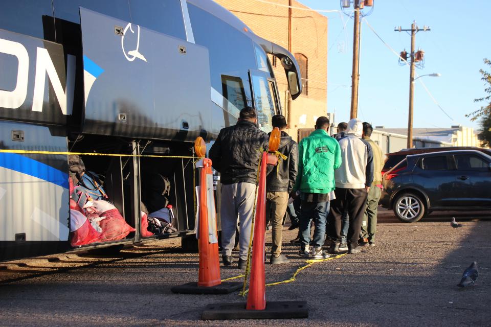 Migrants board a bus behind the Pimeria Alta Historical Society Museum in Nogales after being dropped off by Border Patrol on Dec. 14, 2023.