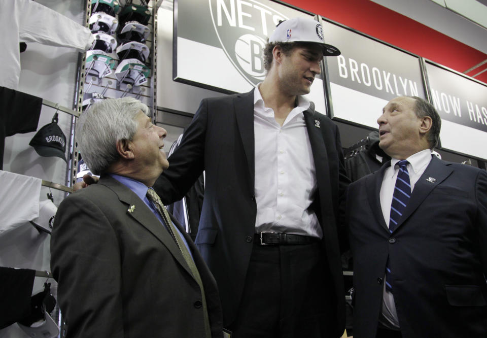 Brooklyn borough of New York president Marty Markowitz, left, Brooklyn Nets basketball team player Brook Lopez, center, and Barclay's Center developer Bruce Ratner talk after a news conference to unveil the new team logos in Brooklyn, Monday, April 30, 2012. The Nets will be moving from New Jersey to the new Barclays Center in Brooklyn for the 2012-2013 NBA basketball season. (AP Photo/Seth Wenig)