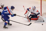 Unted States' goalkeeper Alex Nedeljkovic, right, makes a save in front of Slovakia's Martin Fasko-Rudas, second left, during the preliminary round match between United States and Slovakia at the Ice Hockey World Championships in Ostrava, Czech Republic, Monday, May 13, 2024. (AP Photo/Darko Vojinovic)