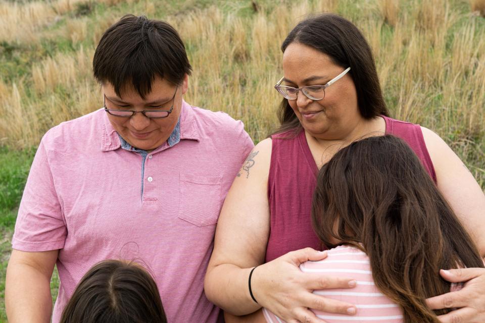 Norma LeRoy, left, and Alice Johnson hold their daughters, ages 7 and 12 in Valentine City Park on May 21. They have filed a lawsuit against Cody-Kilgore Unified Schools, alleging that their daughters' hair was cut in violation of Lakota religious and cultural beliefs and their civil rights.