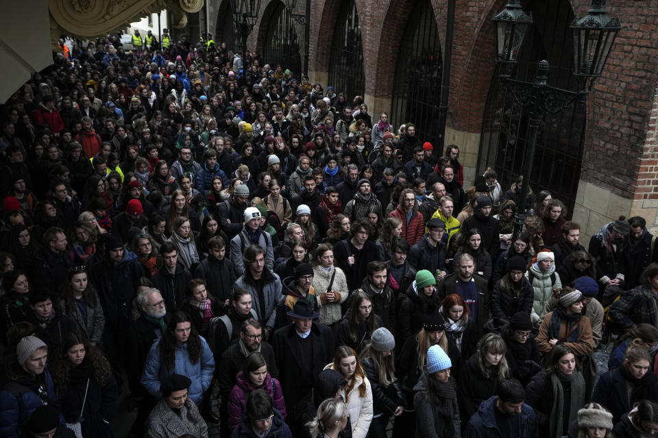 People gather in front of headquarters of Charles University in Prague, Czech Republic, Thursday, Jan. 4, 2024. Thousands of students and other Czechs marched in silence in the Czech capital on Thursday to honor the victims of the country's worst mass killing that left 14 dead on Dec. 21, 2023. (AP Photo/Petr David Josek)