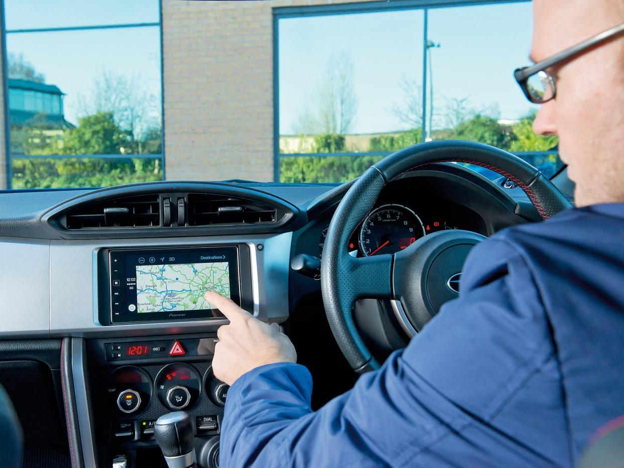 Man using Apple Carplay in car