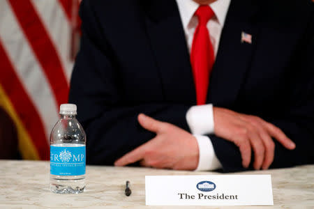 U.S. President Donald Trump, with a bottle of Trump-branded water, speaks to reporters after a security briefing at his golf estate in Bedminster, New Jersey U.S. August 10, 2017. REUTERS/Jonathan Ernst