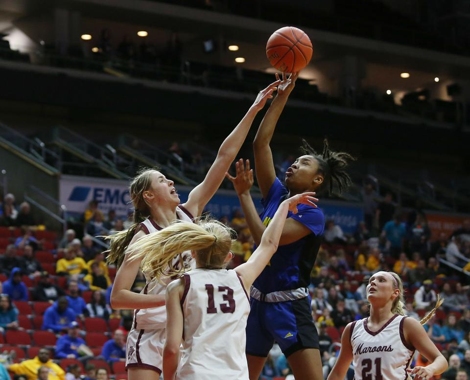 Davenport North's Divine Bourrage takes a shot over Dowling Catholic's Ellie Muller (43) and Ava Zediker (13) during last year's state tournament. All three are back this year and are a few of the top 20 recruits taking to the court at Wells Fargo Arena.
