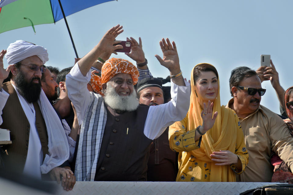 Maulana Fazalur Rehman, center, and Maryam Nawaz, second right, leaders of Pakistan Democratic Alliance, wave to supporters during a protest outside the Supreme Court, in Islamabad, Pakistan, Monday, May 15, 2023. Thousands of Pakistani government supporters converged on the country's Supreme Court, in a rare challenge to the nation's judiciary. Protesters demanded the resignation of the chief justice over ordering the release of former Prime Minister Imran Khan. (AP Photo/Anjum Naveed)