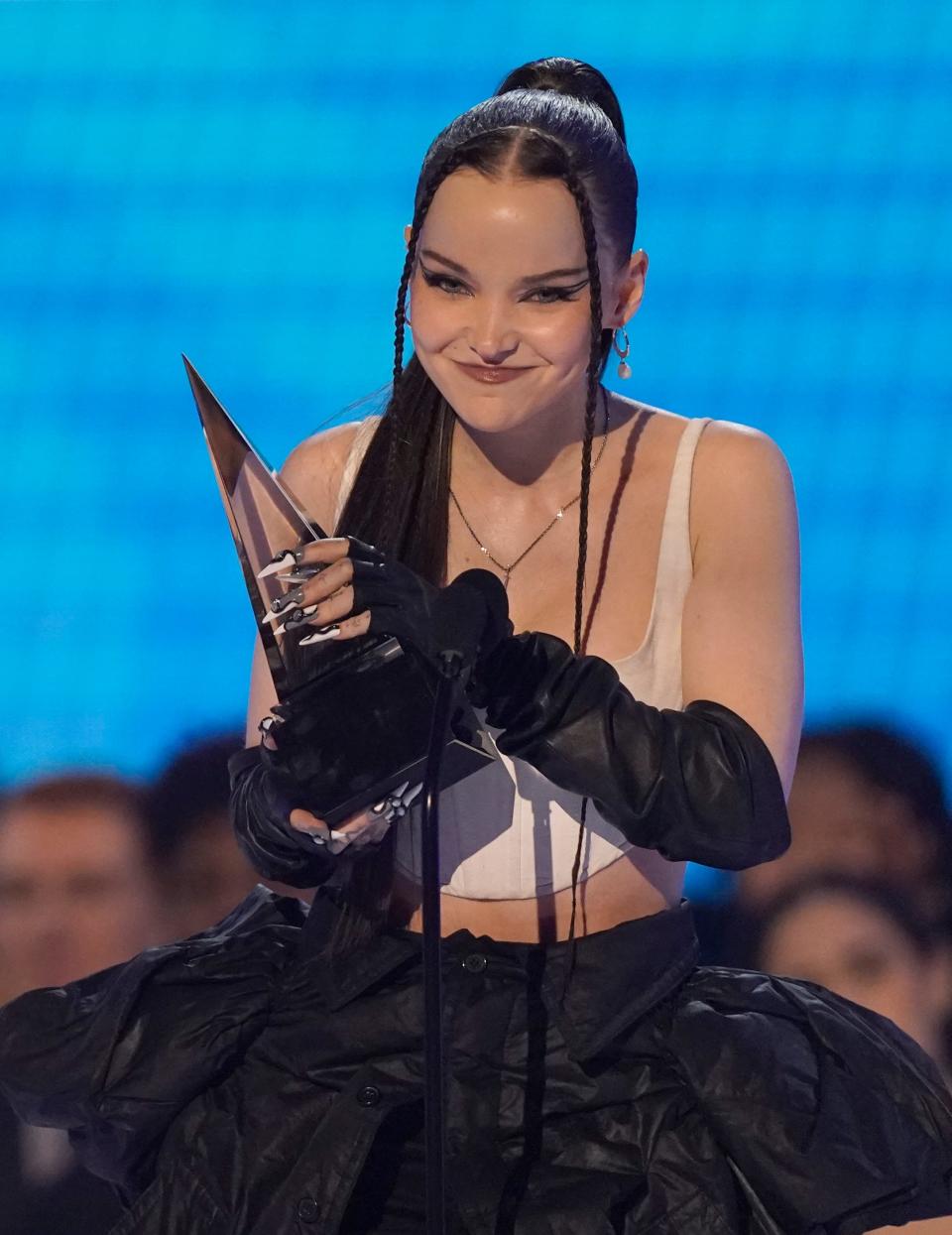 Dove Cameron accepts the award for new artist of the year at the American Music Awards on Nov. 20, 2022, in Los Angeles.