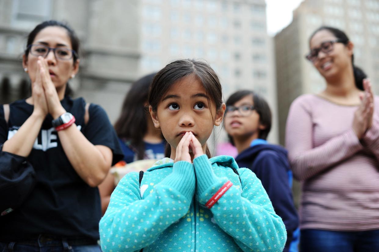 People attend an open-air mass celebrated by Pope Francis at Benjamin Franklin Parkway in Philadelphia, Pennsylvania, in September 2015. New data shows that young women are leaving Christian churches in greater numbers than young men, reversing the trends of previous generations.