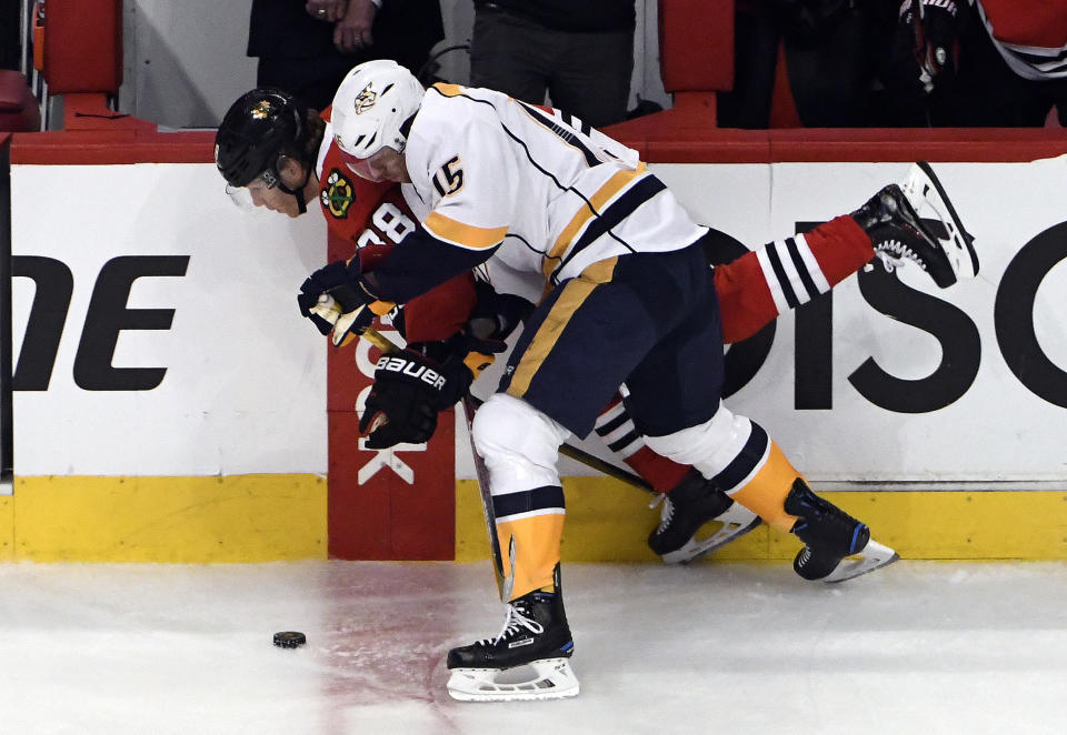 Nashville Predators center Craig Smith (15) and Chicago Blackhawks right wing Patrick Kane (88) go for the puck during the first period in Game 2 of a first-round NHL hockey playoff series, Saturday, April 15, 2017, in Chicago. (AP Photo/David Banks)