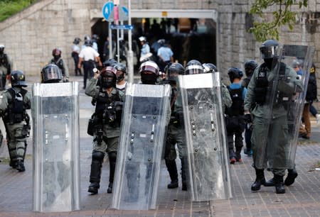 Riot police officers block the street during an anti-government protest in Tai Po district, in Hong Kong