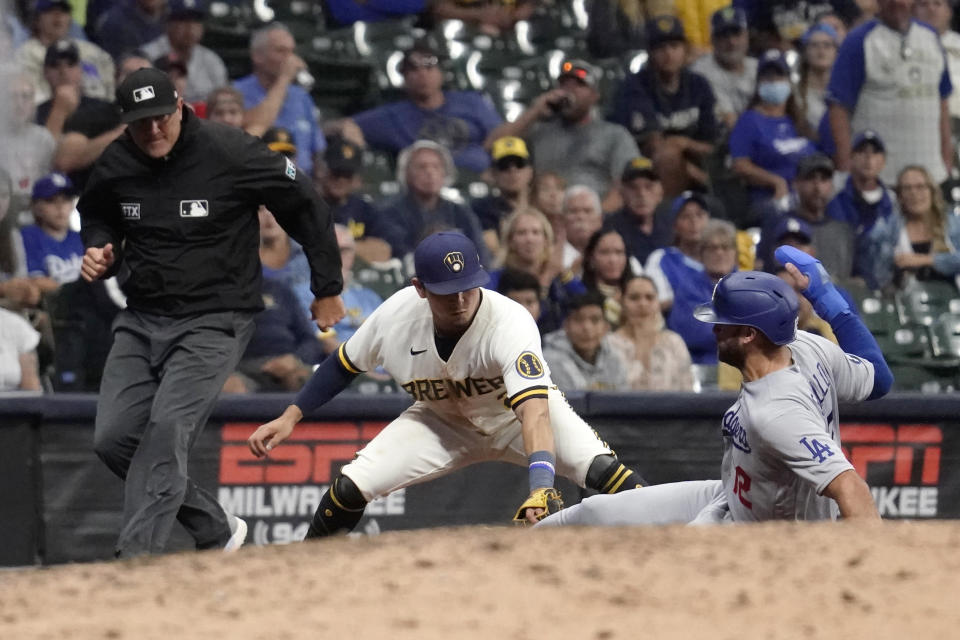 Los Angeles Dodgers' Joey Gallo (12) is tagged out at third base by Milwaukee Brewers' Luis Urias while trying to advance on a ground ball during the 10th inning of a baseball game Tuesday, Aug. 16, 2022, in Milwaukee. (AP Photo/Aaron Gash)