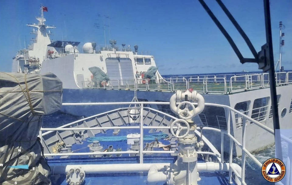In this photo provided by the Philippine Coast Guard, a Chinese Coastguard ship, front, allegedly blocks the path of a Philippine Coast Guard ship near the Philippine-occupied Second Thomas Shoal, South China Sea during a re-supply mission on Saturday Aug. 5, 2023. The Philippine military condemned on Sunday a Chinese coast guard ship's "excessive and offensive" use of a water cannon to block a Filipino supply boat from delivering new troops, food, water and fuel to a Philippine-occupied shoal in the disputed South China Sea. (Philippine Coast Guard via AP)