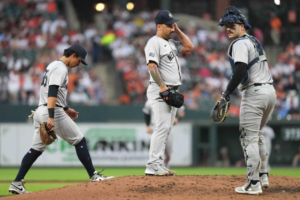 Apr 30, 2024; Baltimore, Maryland, USA; New York Yankees pitcher Nestor Cortes (65) awaits a fourth inning mound visit from catcher Austin Wells (28) and third baseman Oswaldo Cabrera (95) against the Baltimore Orioles at Oriole Park at Camden Yards. Mandatory Credit: Mitch Stringer-USA TODAY Sports