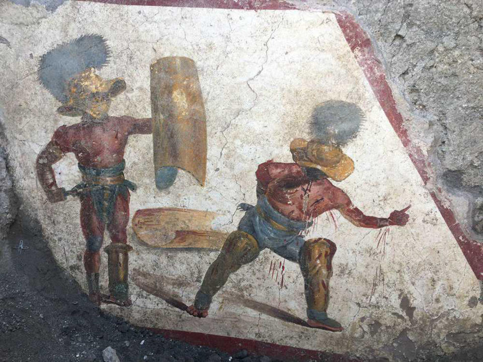 A view of a well-preserved fresco depicting fighting gladiators in the ancient Roman city of Pompeii, Italy, recently unearthed by archeologists. The new discovery -- located in the Regio V site, north of the archaeological park -- was unveiled on Friday and it's not open to the public yet. (Archeological Park of Pompeii via AP)