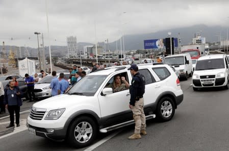 A federal police officer blocks the Rio-Niteroi Bridge, where armed police surrounded a hijacked passenger bus in Rio de Janeiro