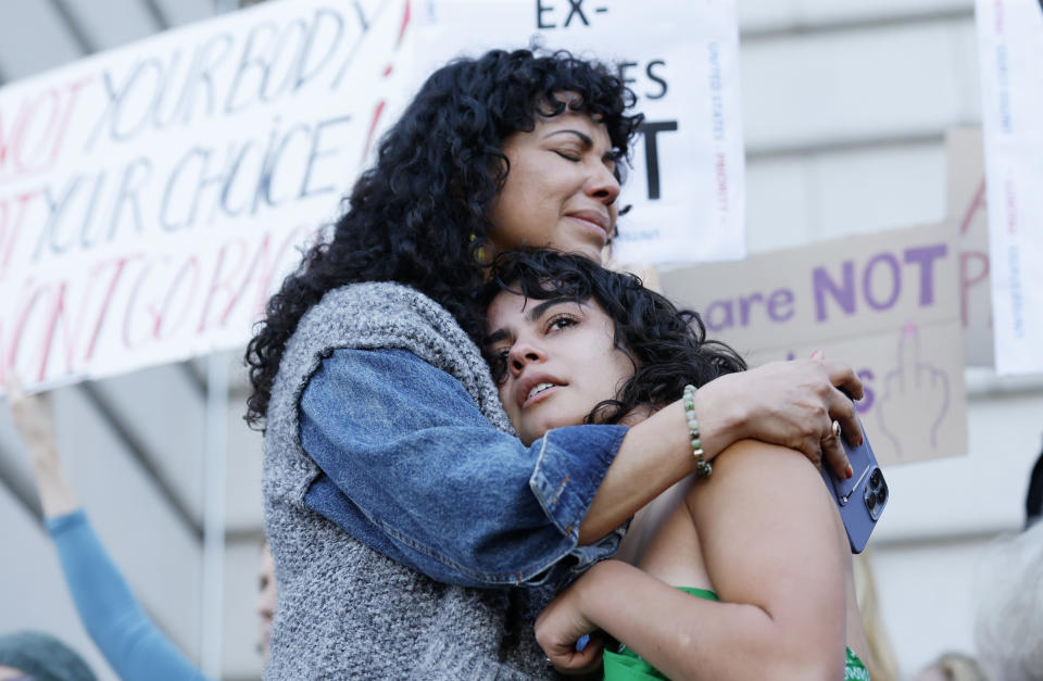 FILE - Mitzi Rivas hugs her daughter Maya Iribarren as abortion-rights protesters gather following the Supreme Court's decision to overturn Roe v. Wade, at San Francisco City Hall in San Francisco, June 24, 2022. Reproductive freedom was not the only demand of second-wave feminism, as the women's movement of the '60s and '70s is known, but it was surely one of the most galvanizing issues, along with workplace equality. (AP Photo/Josie Lepe, File)