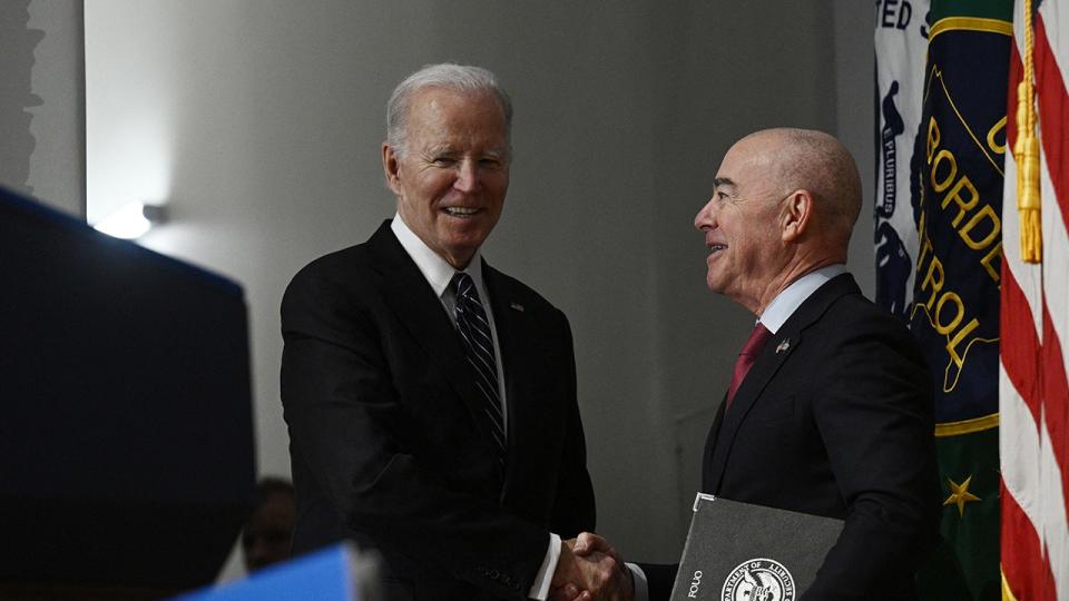 Biden and Mayorkas shake hands