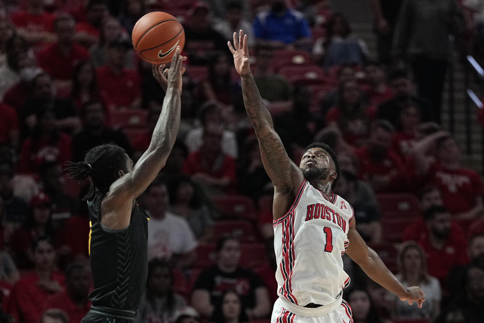 Norfolk State guard Christian Ings misses a shot under pressure from Houston guard Jamal Shead (1) during the first half of an NCAA college basketball game, Tuesday, Nov. 29, 2022, in Houston. (AP Photo/Kevin M. Cox)