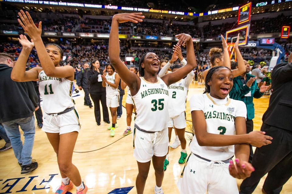 Washington's Kira Reynolds (11), Monique Mitchell (35) and Ryiah Wilson (3) celebrate after winning the Washington vs. Silver Creek girls state championship basketball game Saturday, Feb. 26, 2022 at Gainbridge Fieldhouse in Indianapolis. 