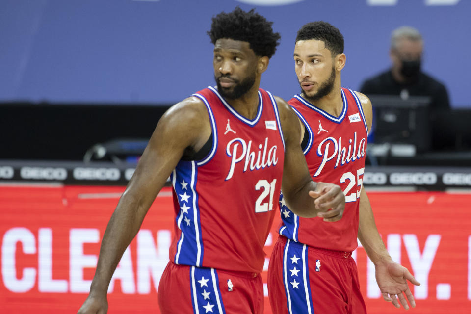 Joel Embiid #21 and Ben Simmons #25 of the Philadelphia 76ers look on against the Miami Heat at the Wells Fargo Center on January 14, 2021 in Philadelphia, Pennsylvania. The 76ers defeated the Heat 125-108. NOTE TO USER: User expressly acknowledges and agrees that, by downloading and or using this photograph, User is consenting to the terms and conditions of the Getty Images License Agreement. (Photo by Mitchell Leff/Getty Images)