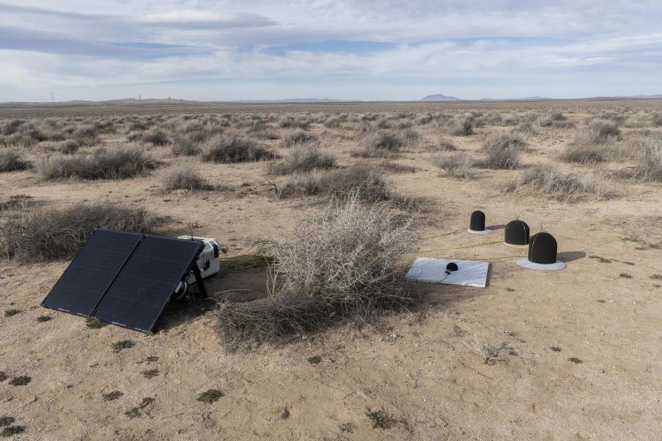 microphones and wind gauges attached to solar panels in the desert
