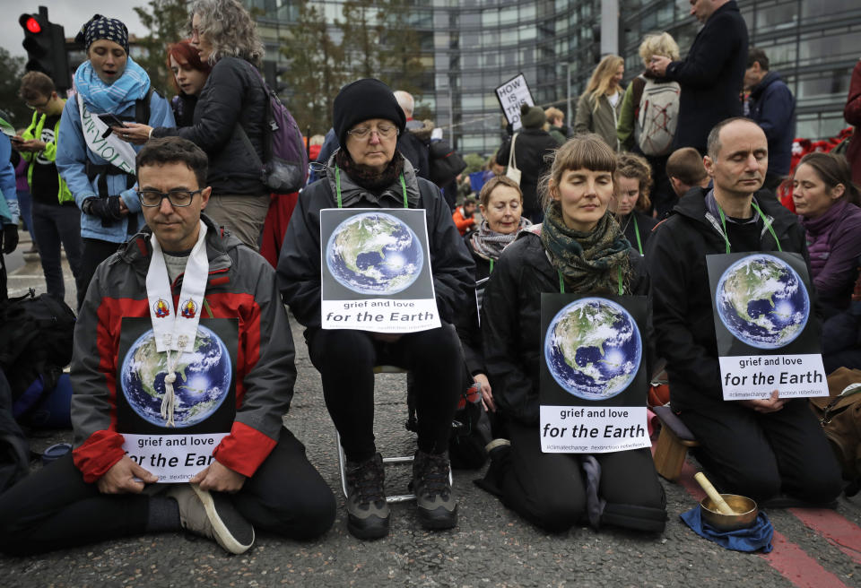 Climate protestors block Lambeth bridge leading to Britain's Parliament in central London Monday, Oct. 7, 2019, in an attempt to disrupt the heart of government. (AP Photo/Matt Dunham)