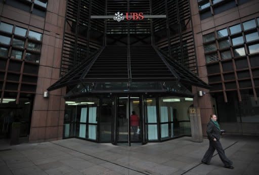 A woman walks past the offices of Swiss bank UBS in the City of London. UBS trader Kweku Adoboli, who gambled away $2.3 billion of the Swiss bank's money, has been jailed for seven years in London for Britain's biggest-ever fraud