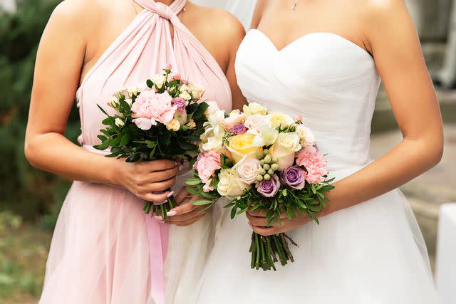 <p>Getty</p> Stock image of a bride and bridesmaid.