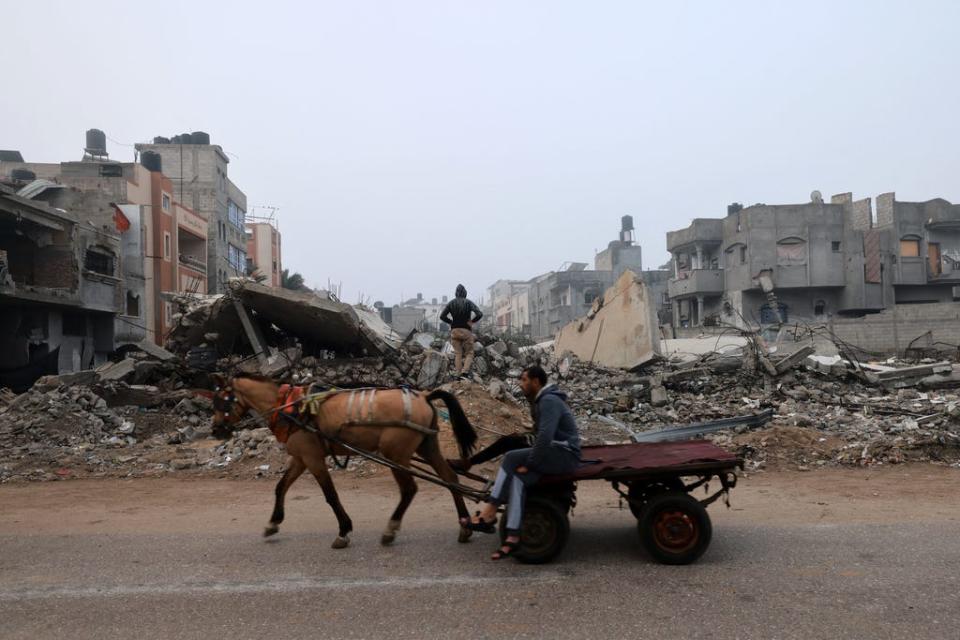 A man rides a horse-pulled cart along a street ravaged by Israeli bombing in Rafah in the southern Gaza Strip on Feb. 9, 2024, amid the ongoing conflict between Israel and the Palestinian militant group Hamas.