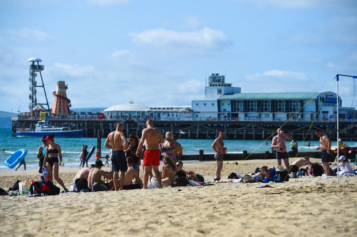 People enjoy the September heatwave on Bournemouth beach (PA)