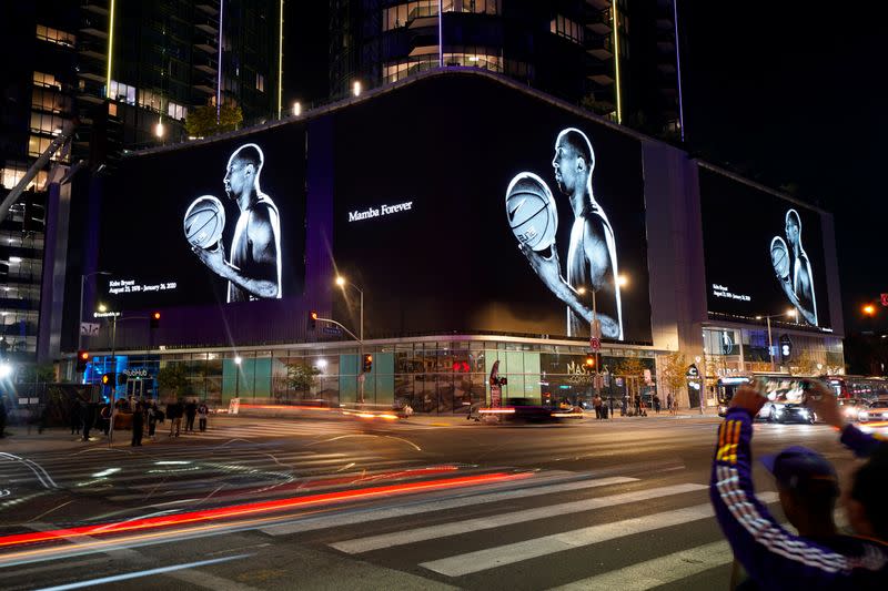 The street son L.A. are lit up with images of NBA basketball star Kobe Bryant as fans pay their respects outside the Staples Center in Los Angeles