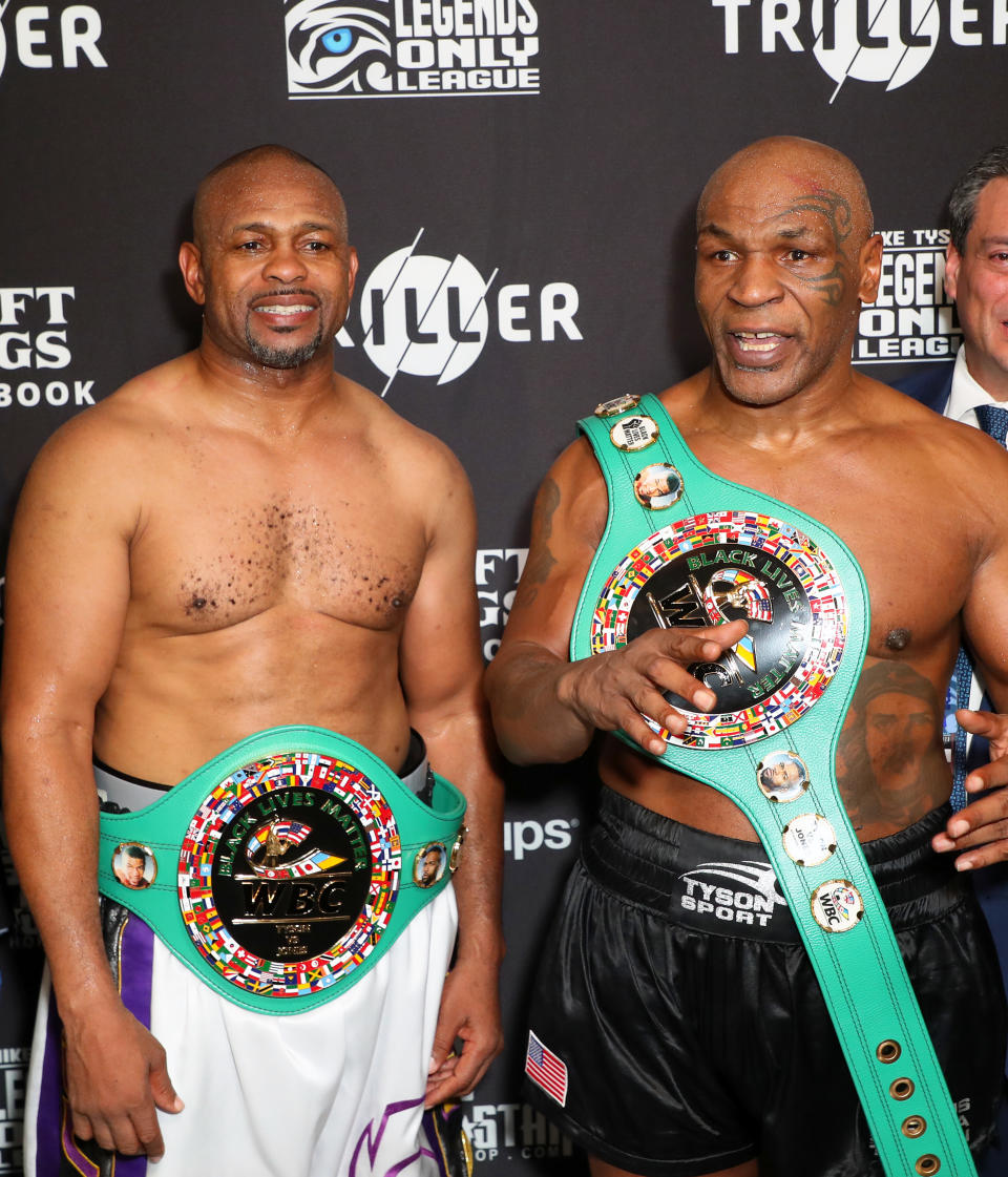 LOS ANGELES, CALIFORNIA - NOVEMBER 28: Roy Jones Jr. (L) and Mike Tyson celebrate their split draw during Mike Tyson vs Roy Jones Jr. presented by Triller at Staples Center on November 28, 2020 in Los Angeles, California. (Photo by Joe Scarnici/Getty Images for Triller)