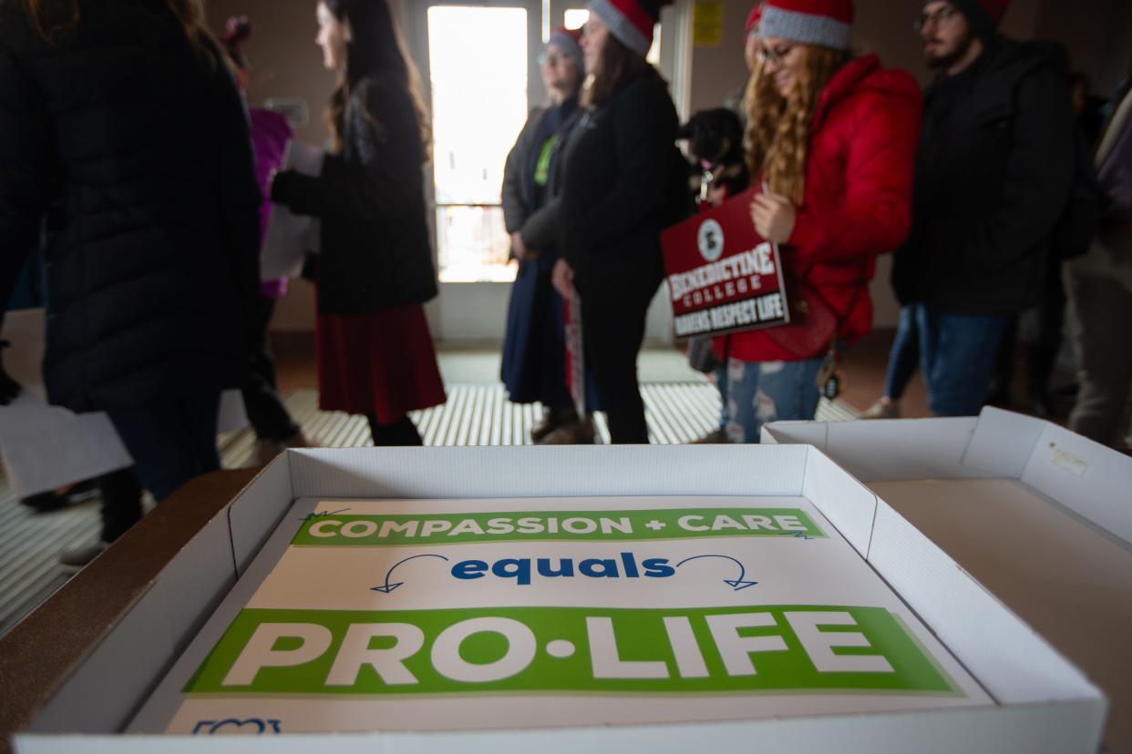 Various anti-abortion signs are handed out to supporters at a March for Life rally in downtown Topeka in January.