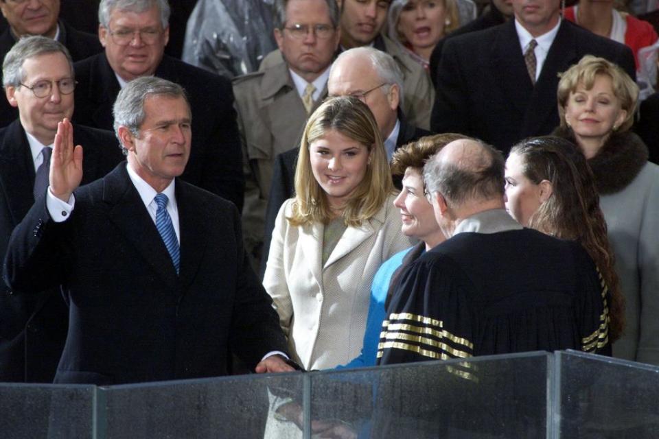 Jenna Bush, middle, stands beside her dad, President George W. Bush, as he takes the oath of office at the U.S. Capitol on Jan. 20, 2001. (Photo: TIM CLARY/AFP via Getty Images)