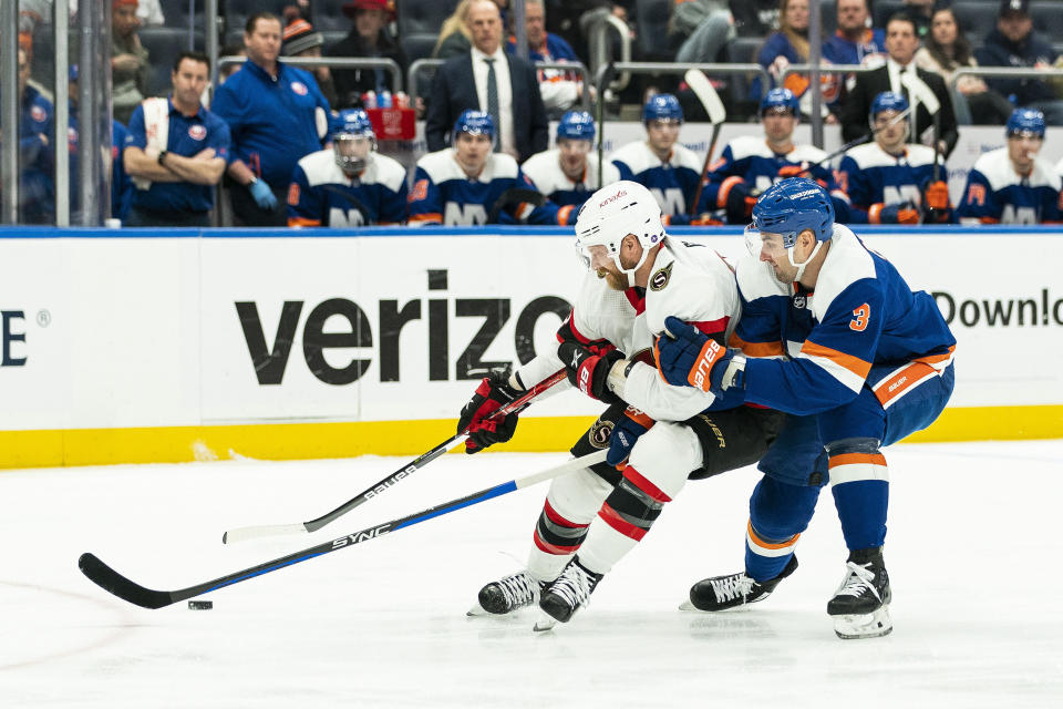 New York Islanders defenseman Adam Pelech (3) fights for control of the puck against Ottawa Senators right wing Claude Giroux (28) during the first period of an NHL hockey game Tuesday, Feb. 14, 2023, in Elmont, N.Y. (AP Photo/Eduardo Munoz Alvarez)