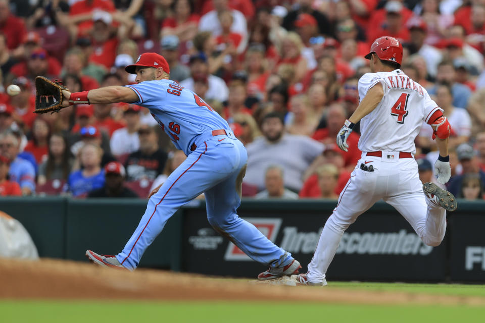 St. Louis Cardinals' Paul Goldschmidt, left, catches the throw as Cincinnati Reds' Shogo Akiyama (4) reaches first base safely during the second inning of a baseball game in Cincinnati, Saturday, July 24, 2021. (AP Photo/Aaron Doster)