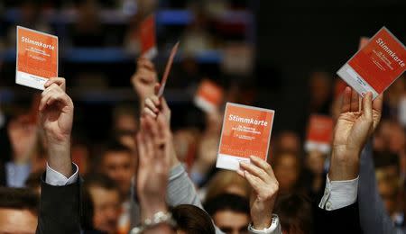Christian Democratic Union (CDU) delegates vote on a declaration about refugees during the CDU party congress in Karlsruhe, Germany December 14, 2015. REUTERS/Kai Pfaffenbach