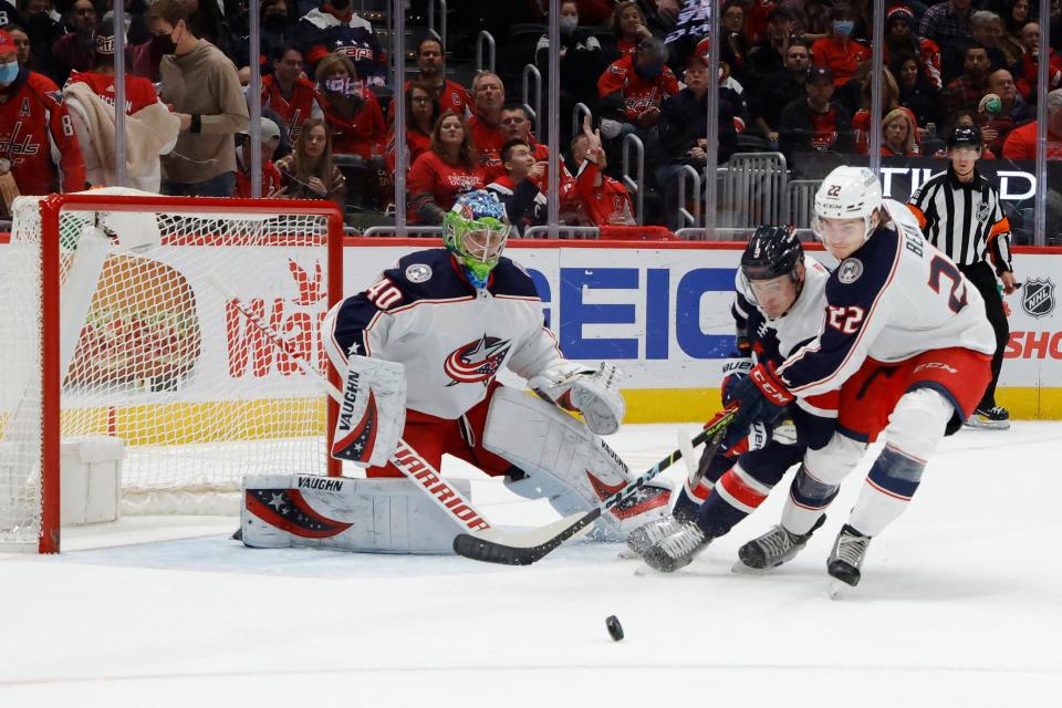 Dec 4, 2021; Washington, District of Columbia, USA; Washington Capitals defenseman Dmitry Orlov (9) and Columbus Blue Jackets defenseman Jake Bean (22) battle for the puck in front of Blue Jackets goaltender Daniil Tarasov (40) during the first period at Capital One Arena. Mandatory Credit: Geoff Burke-USA TODAY Sports