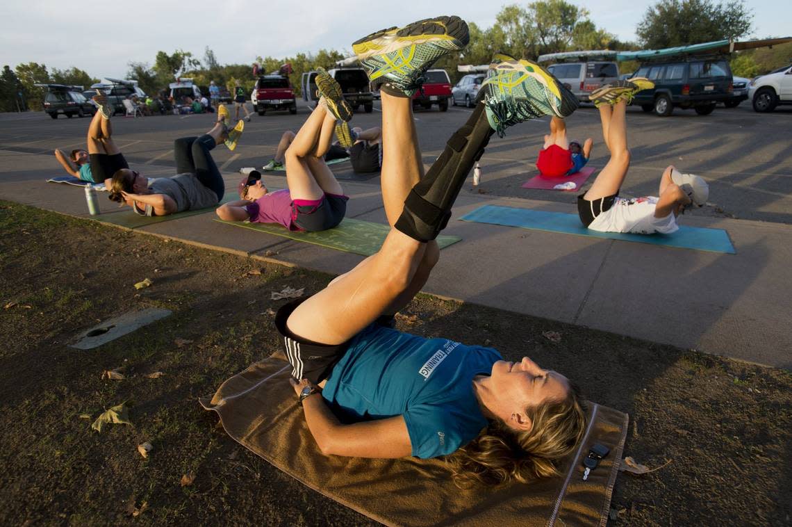 World champion paracyclist Jamie Whitmore leads core exercises with a group of triathletes she was training at Lake Natoma on Aug.12, 2014, the year she was awarded an ESPN ESPY for Best Female Athlete with a Disability.