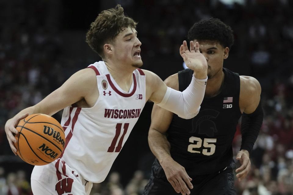 Wisconsin's Max Klesmit drives past Michigan State's Malik Hall during the second half of an NCAA college basketball game Tuesday, Jan. 10, 2023, in Madison, Wis. (AP Photo/Morry Gash)