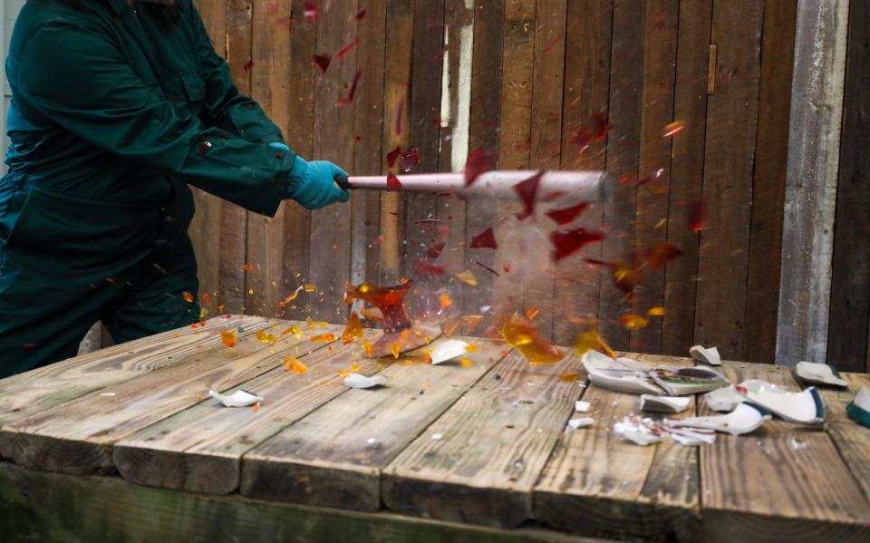 Tiffany Noell uses a baseball bat to shatter a vase on Friday, Aug. 19 at Smithereens' permanent location on the corner of Jones and MLK. Smithereens will be Savannah's premier smash room, where participants can break a variety of objects with mallets, hammers and baseball bats.